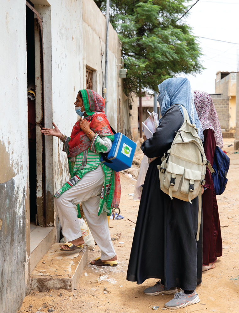 a polio vaccination team visits a home in karachi