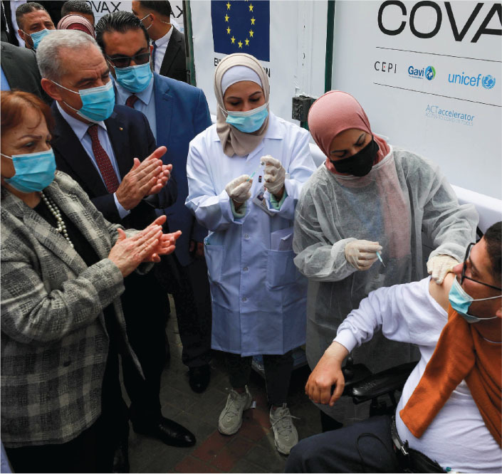 an individual is vaccinated for covid 19 in the west bank city of ramallah in 2021